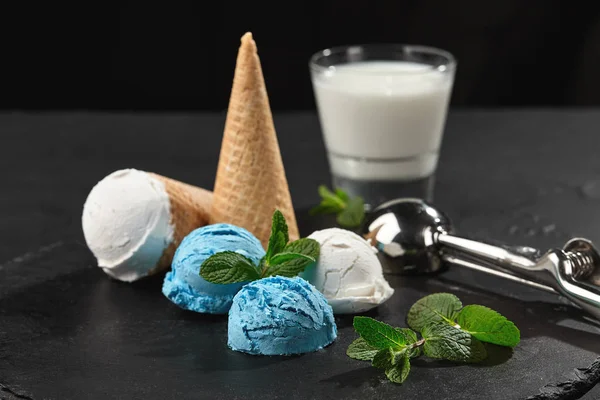 Close-up shot of a creamy and blueberry ice cream served on a dark slate, black background. — Stock Photo, Image