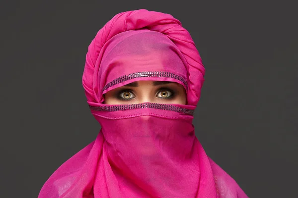 Close-up shot of a young charming woman wearing the pink hijab decorated with sequins. Arabic style. — Stock Photo, Image