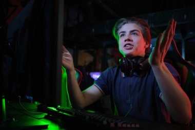 Profesyonel genç kafkas oyuncu onun Pc online oynuyor. Maçı kaybettiği için üzgün.