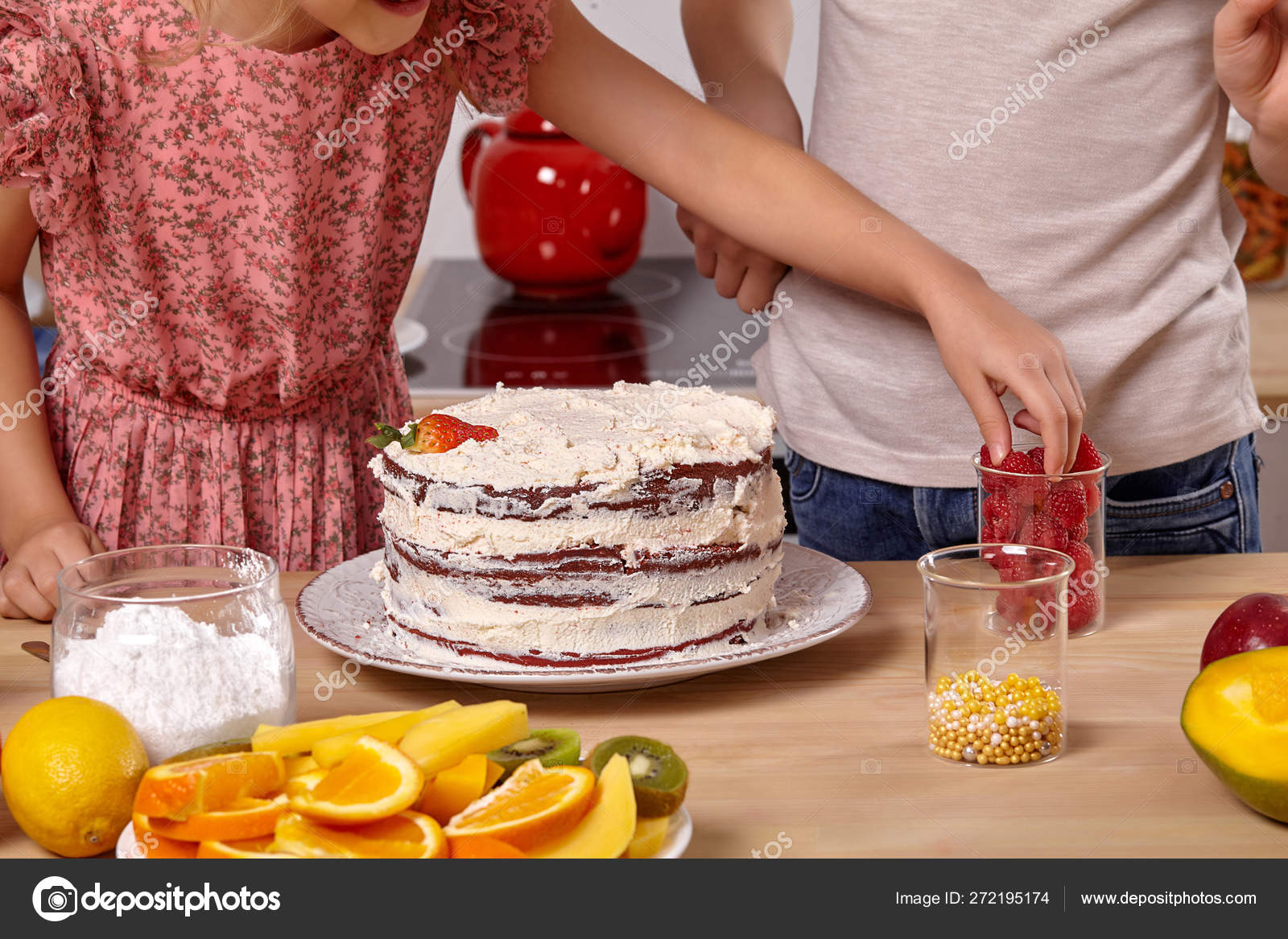 Little friends are making a cake together at a kitchen against a