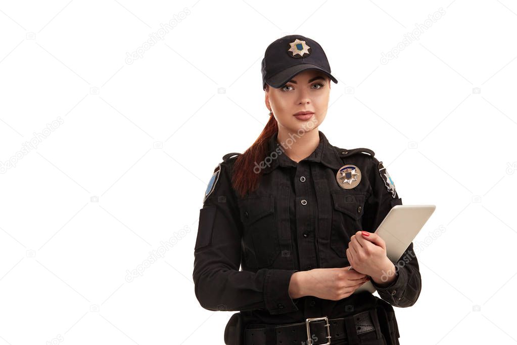 Close-up portrait of a female police officer is posing for the camera isolated on white background.