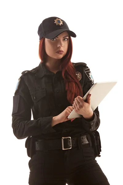 Redheaded female police officer is posing for the camera isolated on white background. — Stock Photo, Image
