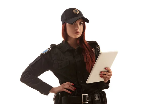 Redheaded female police officer is posing for the camera isolated on white background. — Stock Photo, Image