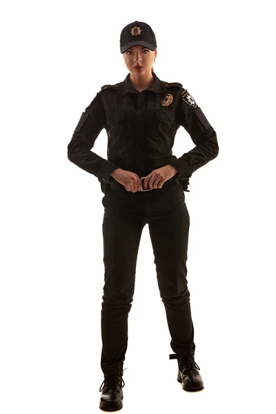 Full length shot of a redheaded female police officer posing for the camera isolated on white background. — Stock Photo, Image