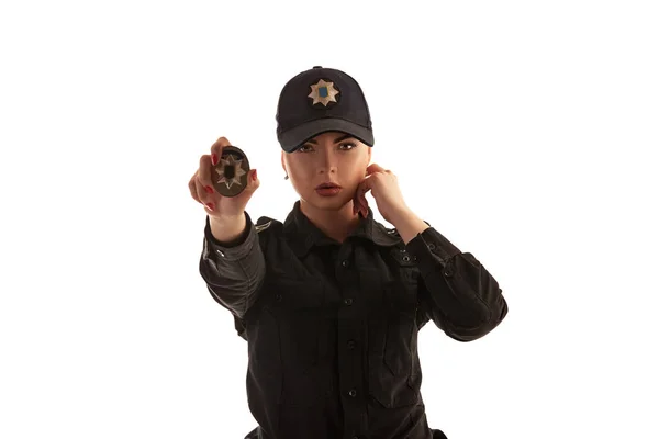 Close-up shot of a redheaded female police officer posing for the camera isolated on white background. — Stock Photo, Image