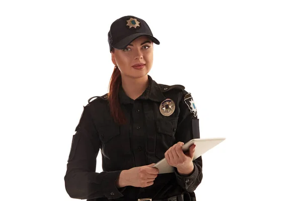 Close-up shot of a redheaded female police officer posing for the camera isolated on white background. — Stock Photo, Image