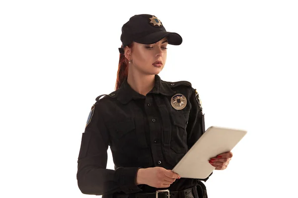 Close-up shot of a redheaded female police officer posing for the camera isolated on white background. — Stock Photo, Image