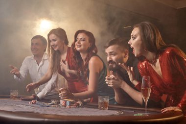 Bir grup zengin genç kumarhanede poker oynuyor..