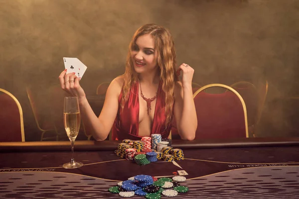 Encantadora mujer con un hermoso peinado y maquillaje perfecto está jugando al poker. Casino Casino . — Foto de Stock