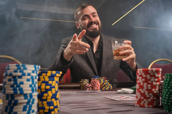 Schöner bärtiger Mann pokert am Tisch im Casino. — Stockfoto