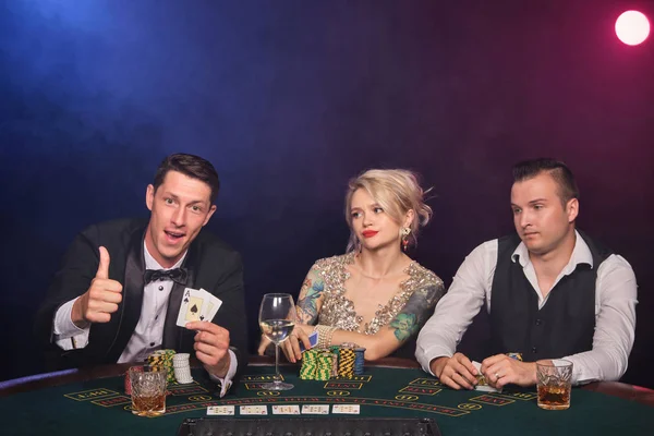 若い裕福な友人のグループがカジノでポーカーをしています。. — ストック写真