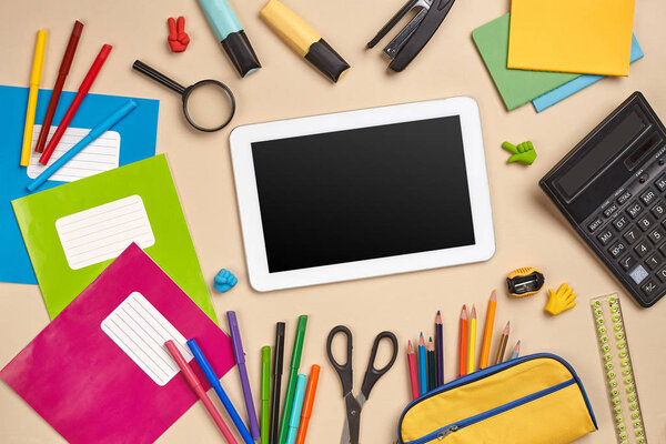 Flat lay photo of workspace desk with school accessories or office supplies.