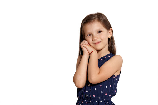 Close-up studio shot of beautiful brunette little girl posing isolated on white studio background.