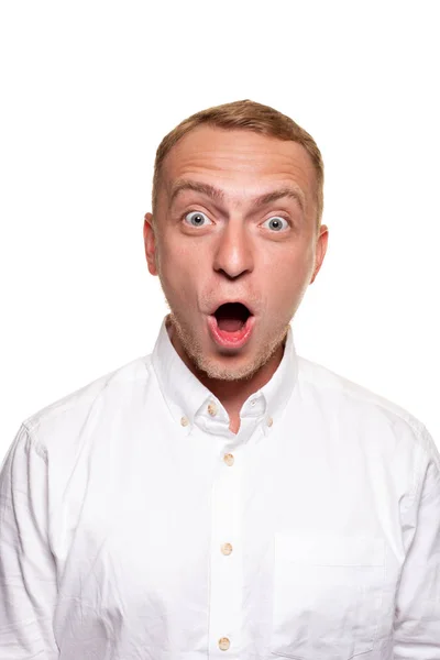 Vertical shot of stupefied stunned shocked young male keeps mouth widely opened, being surprised and very emotional, expresses great surprisment. — Stock Photo, Image