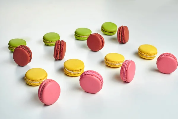 Colored macaron or macaroon, sweet meringue-based confection isolated on white. Close-up, copy space. — Stock Photo, Image