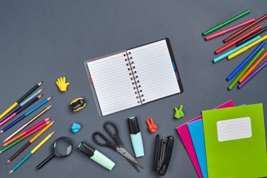 Gri arka plan üzerinde okul aksesuarları veya ofis malzemeleri ile çalışma alanı masasının düz yatıyordu fotoğraf.
