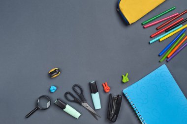Gri arka plan üzerinde okul aksesuarları veya ofis malzemeleri ile çalışma alanı masasının düz yatıyordu fotoğraf.
