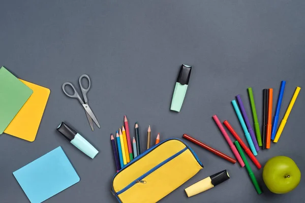 Flat lay photo of workspace desk with school accessories or office supplies on gray background. — Stock Photo, Image