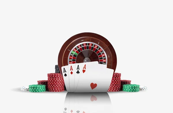 Close-up photo of four aces standing ahead of a brown roulette and chips in piles, isolated on white background. Gambling entertainment. — Stock Photo, Image