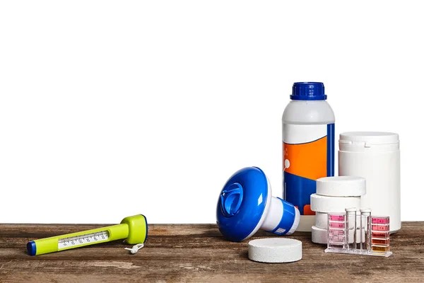 Equipment with chemical cleaning products and tools for the maintenance of the swimming pool on a wooden surface against white background. — Stock Photo, Image