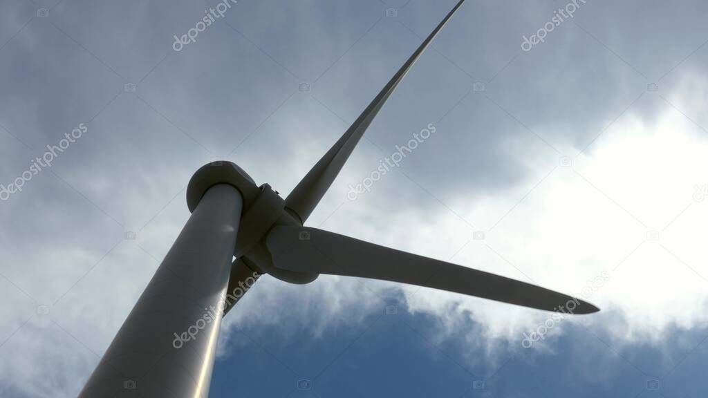 Close up shot of a windmill against a blue sky, wind power technology. View on turbine. Cyprus.