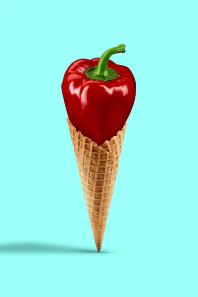 Pimiento rojo maduro en un cono de oblea contra fondo turquesa. Nutrición saludable y cosecha de verduras de temporada. Cerrar, copiar espacio — Foto de Stock