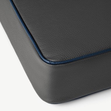 Beyaz arka planda mavi dikişli gri deri çanta köşesi