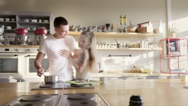 Egy szép pár élvezi napsütéses reggel a konyhában, figyelembe véve a selfies, átölelve és főzés — Stock videók