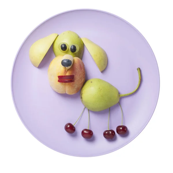Funny fruit dog made on purple plate