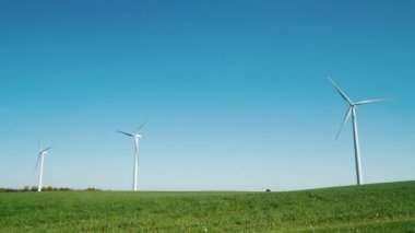 yeşil bir tepede birkaç Rüzgar türbinleri