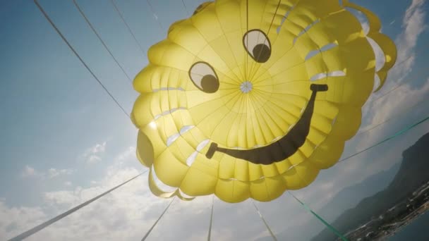 Kemer, Turkey, June 2018: A cool yellow dome of the parachute against the blue sky and the sun poking through it — Stock Video