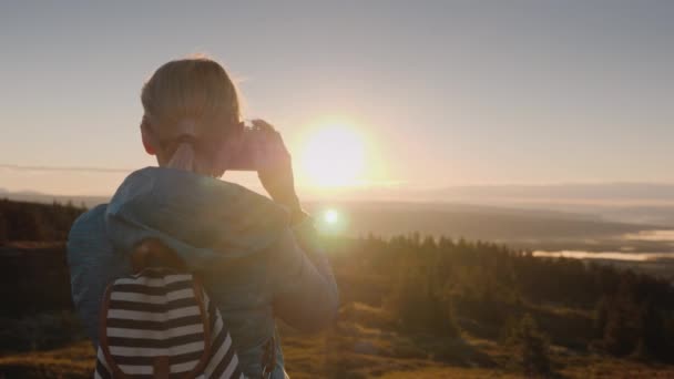 Etkin bir kadın retro bir fotoğraf makinesi ile güzel bir manzara resimlerini alıyor. Dağ tepesinde duran, Norveç'in güzel doğanın bir fotoğraf çeker — Stok video