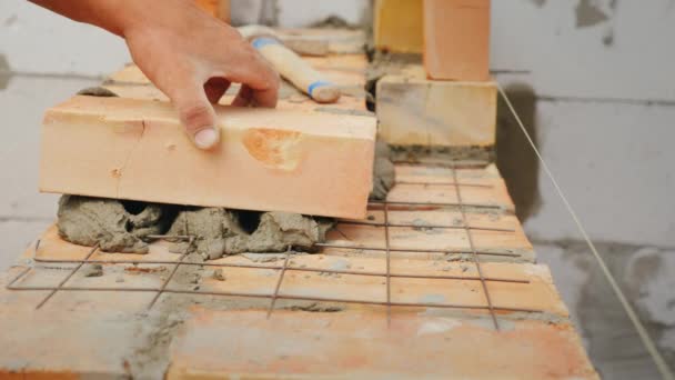 Accuracy and work experience with bricklaying of walls for a residential house is a pledge of heat and strength of the structure — Stock Video