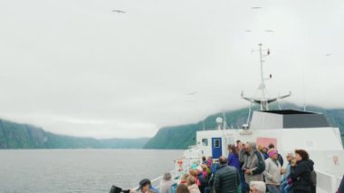 Geirangerfjorden, Norveç, Temmuz 2018: Martı besleme bir seyahat gemisinde turist bir grup