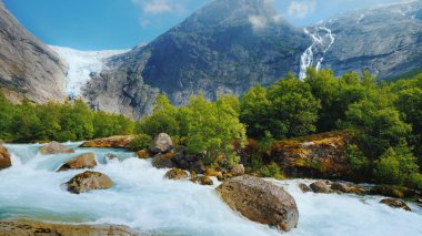 The incredible nature of Norway is a turbulent river from the melted waters of the Briksdal Glacier clipart