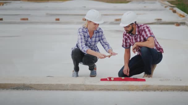 The quality control inspector photographs the readings of the device on the construction site. Quality construction without defects. Top view — Stock Video