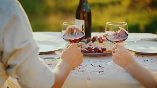 Um jovem casal degustação de vinho, suavemente sacode uma bebida em um copo — Vídeo de Stock