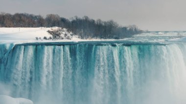 View from the Canadian coast to the amazing Niagara Falls in the winter season clipart