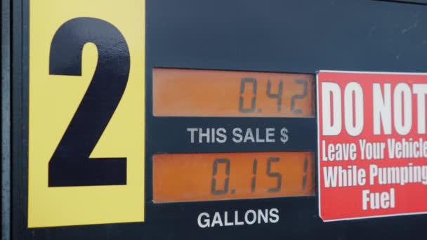 The meter shows the amount of fuel in gallons and the dollar amount. With a red warning next to the meter — Stock Video