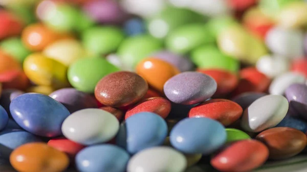 Colorful candy, bright background of round candies in the glaze