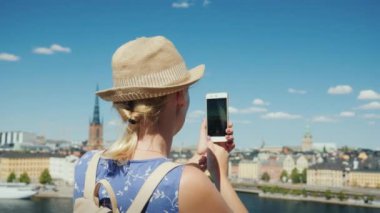 Bir kadın İsveç 'teki Stockholm şehrinin güzel bir manzarasını, dikiz manzarasını çekiyor. İskandinavya konseptinde turizm