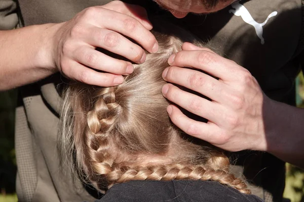 Vérification des cheveux d'une jeune fille pour les poux de tête — Photo