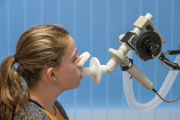 A young girl with asthma in the hospital having a lung function test.