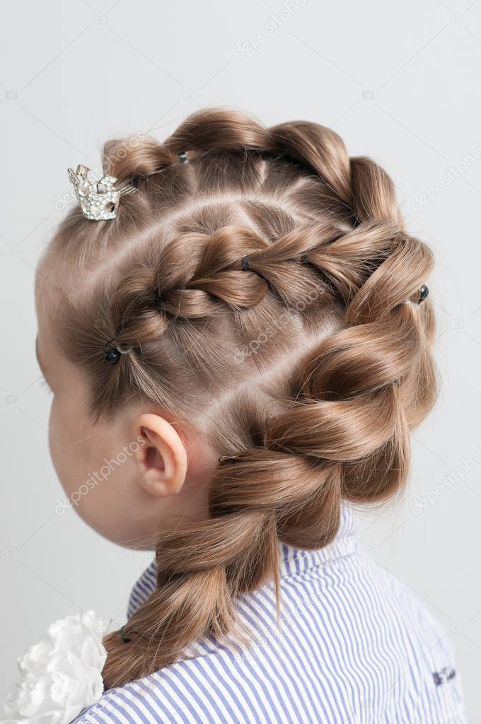 festive hairstyle from braid on a girl with long hair back view