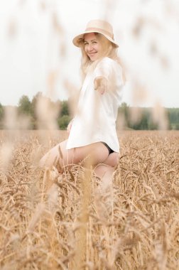 Bir buğday tarlasında genç sarışın kadın