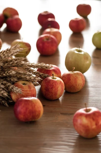 Natural products of nature. Red apples and ears of wheat