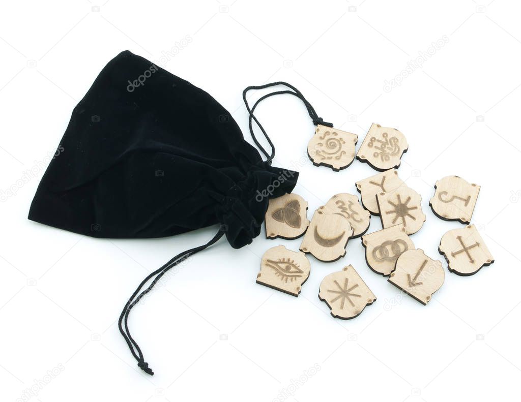 Runes and velvet bag on white backgroun