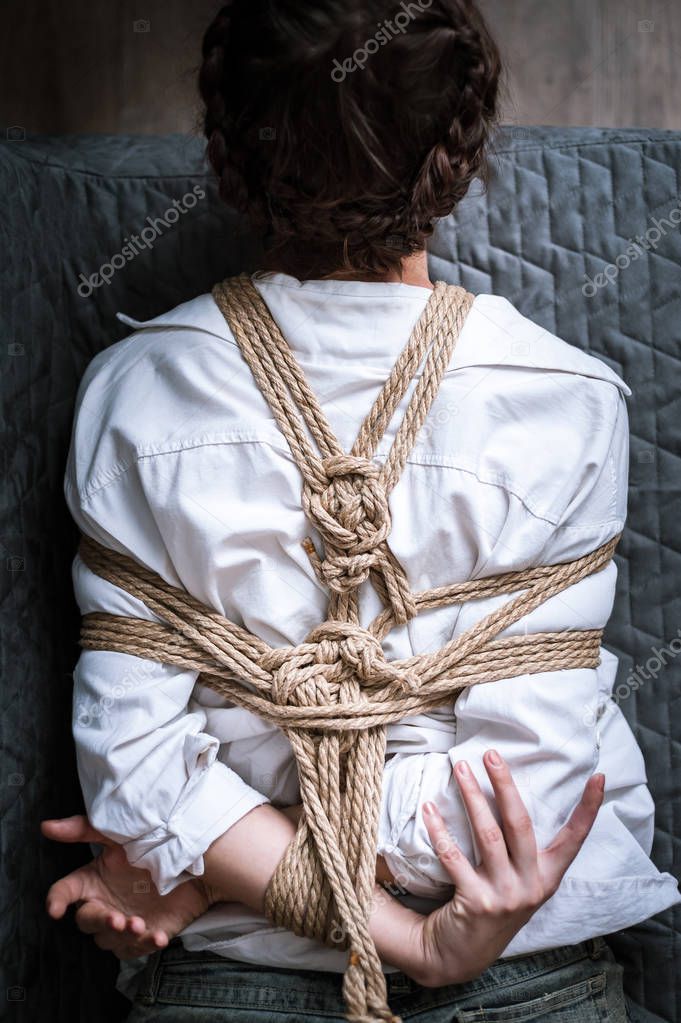Woman bound with a rope in Japanese technique shibari