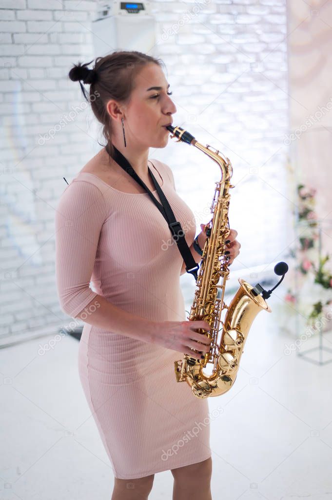 Beautiful girl playing saxophone
