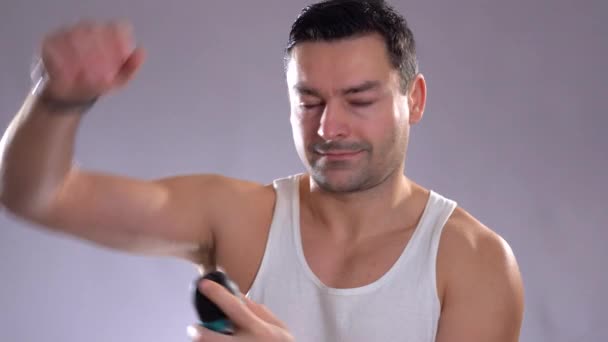 Gente hispana y belleza masculina. Hombre metrosexual confiado usando desodorante en aerosol en la piel de las axilas — Vídeo de stock